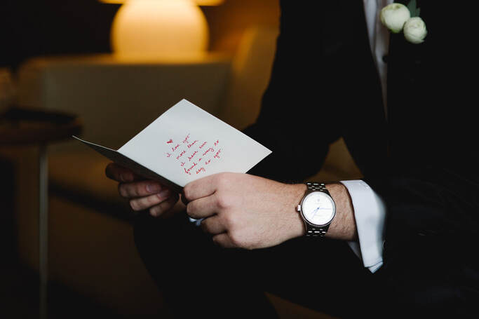 Man in suit holding open greeting card